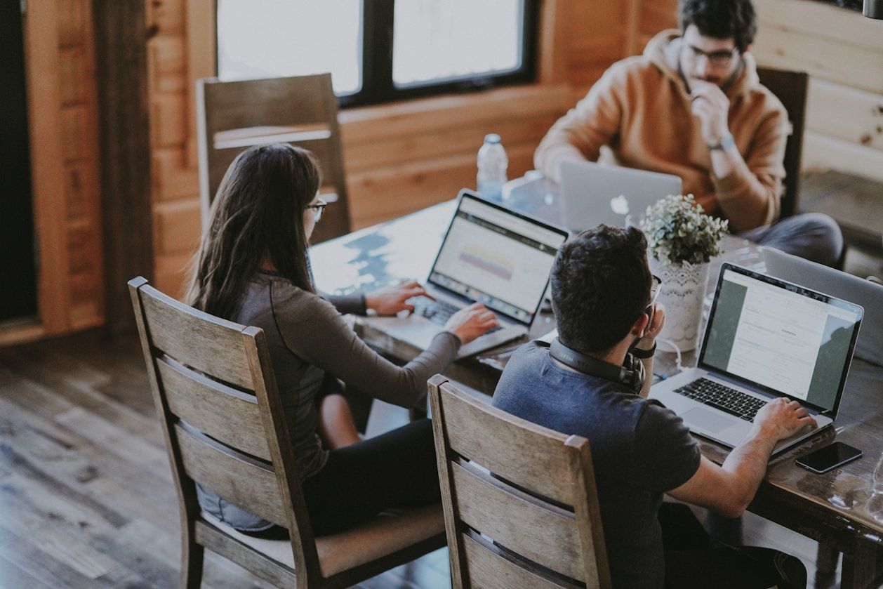 A team of people working together at laptops